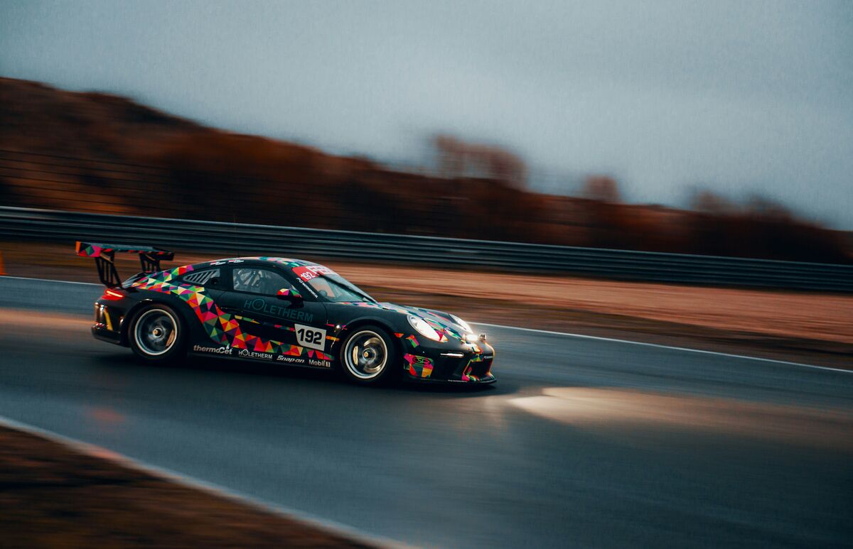Porsche GT3 Cup car at speed at dusk