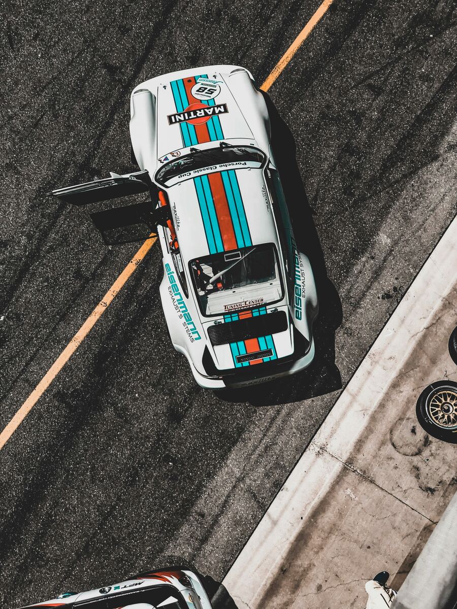 Top-down view of a Martini-livery Porsche race car