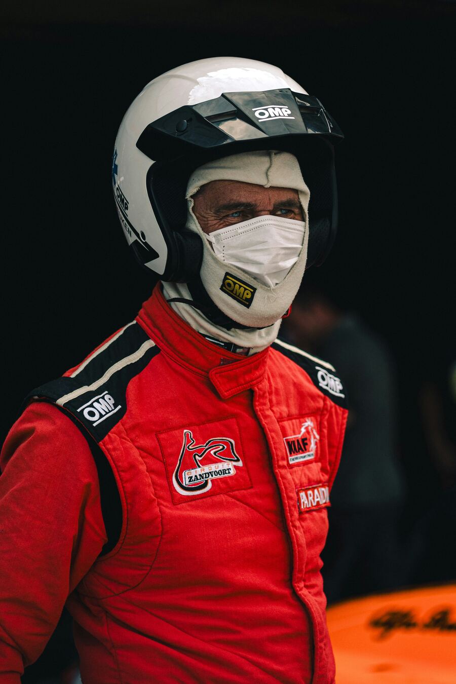 Racing driver in helmet and race suit